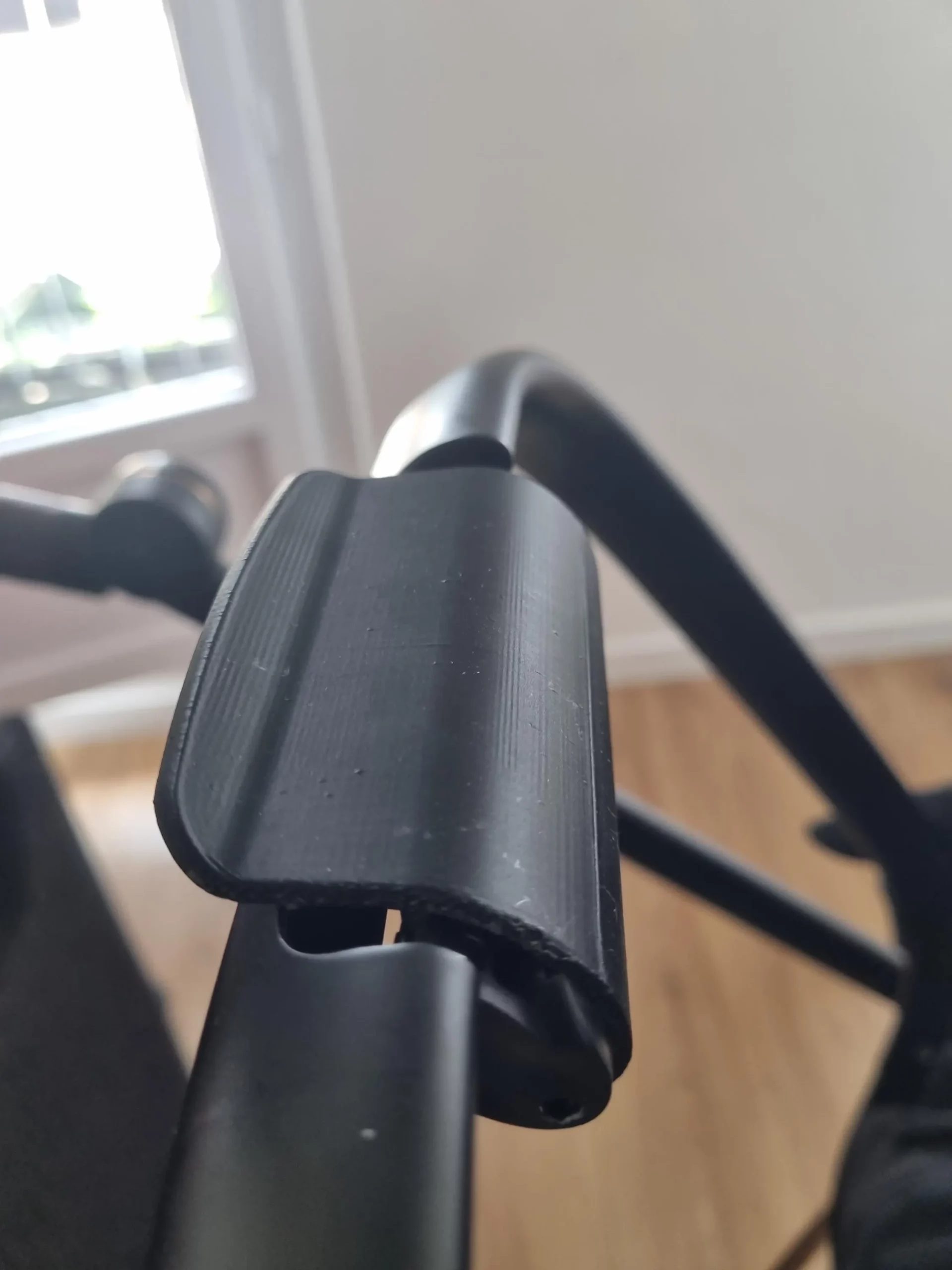3D-printed replacement recline handle installed on a Cybex stroller backrest